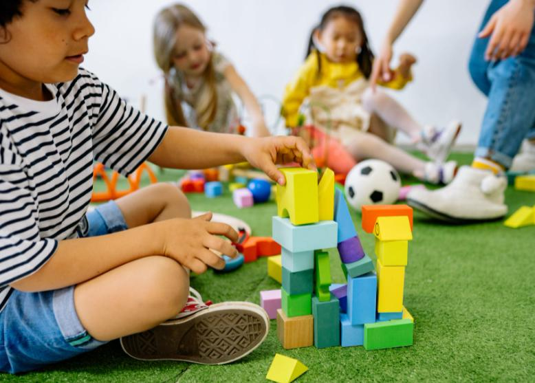 Wooden Building Blocks: children playing together with wooden building blocks